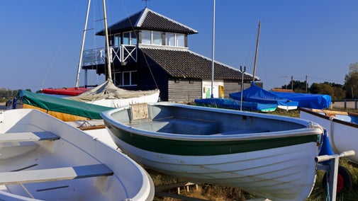 Boats in front of the National Trust Information Centre and observation point at Morston Quay.